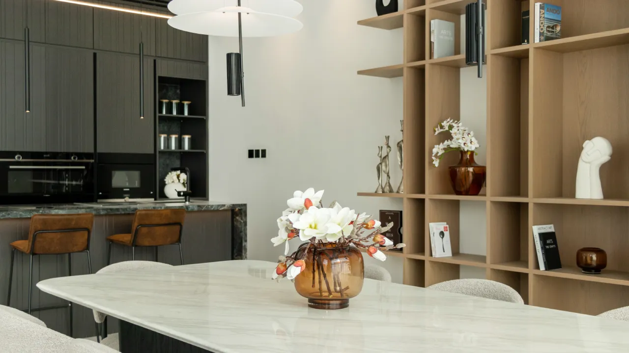 Jumeirah Islands home design with marble dining table and custom wood shelving Ground floor area design with marble dining table and custom wood shelving