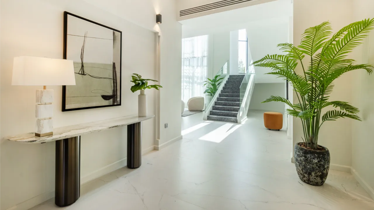 Jumeirah Islands home remodeling entrance with pale stone flooring and indoor plants Home renovation entrance with pale stone flooring and indoor plants