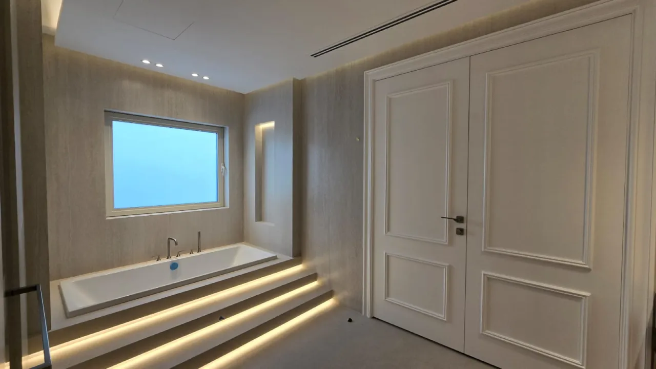 Old villa bathroom refurbishment in Meadows Dubai with new tiles, bathtub, vanity, lighting, and renewed finishes
